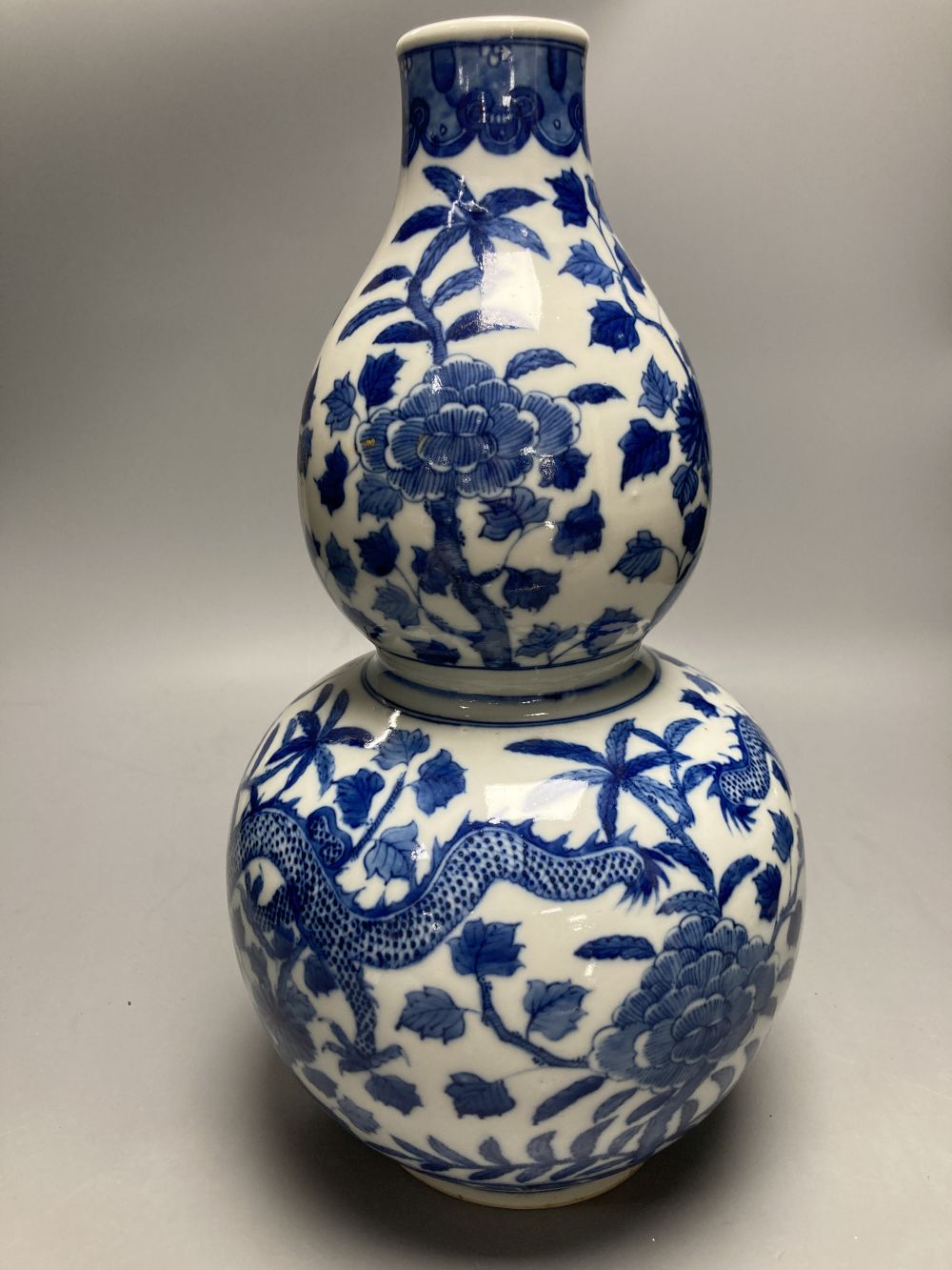 A large Chinese double gourd vase, blue and white dragon design, height 38cm